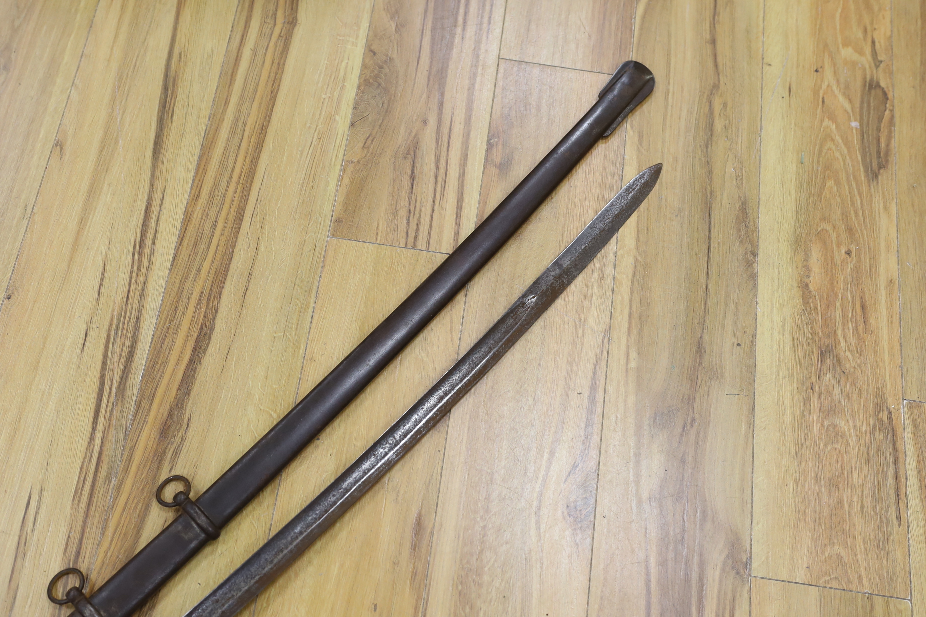 A pair of late 19th century German swords, one in its scabbard, together with another unrelated scabbard, made for the international arms trade, probably in Solingen, blade 89cm. Condition - fair, scabbards are 87cm and